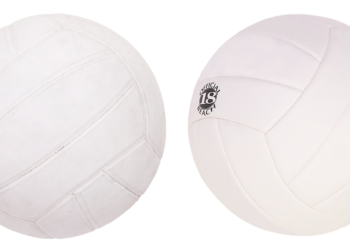 Beyaz zemin üzerinde iki adet klasik voleybol topu duruyor.