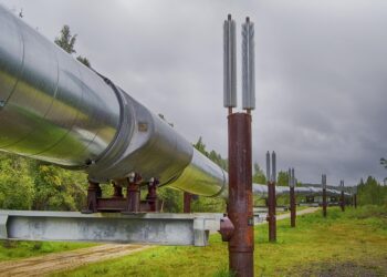 Araziden geçen büyük endüstriyel petrol boru hattı ve destek sütunları.